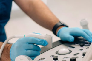 a person in blue gloves operating a machine
