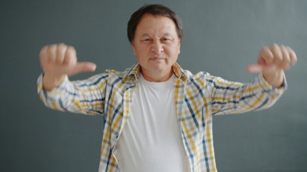 Man giving thumbs down gesture with both hands.