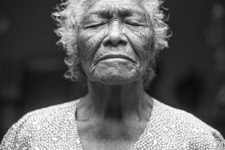grayscale photo of closed-eyes woman