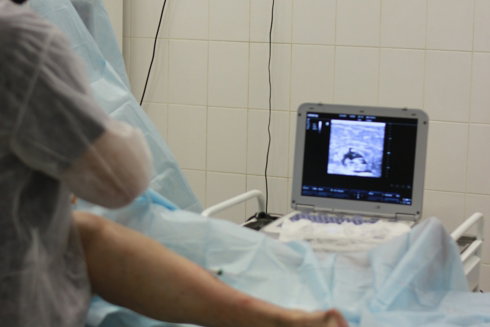 a person in a hospital bed with a laptop